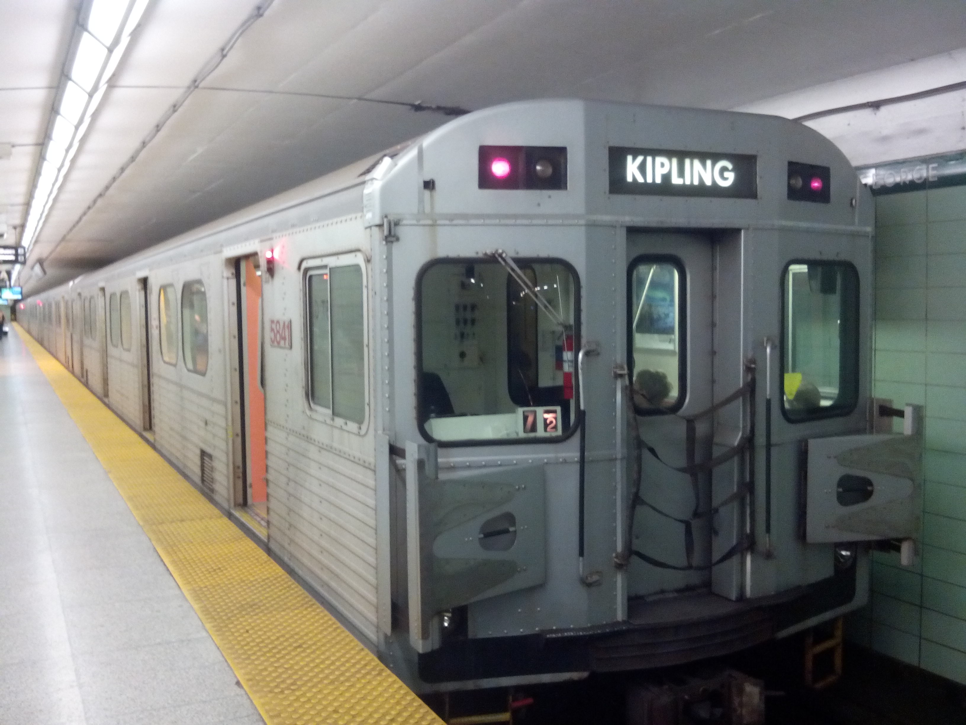 A Toronto subway H-series train stopped at a station.